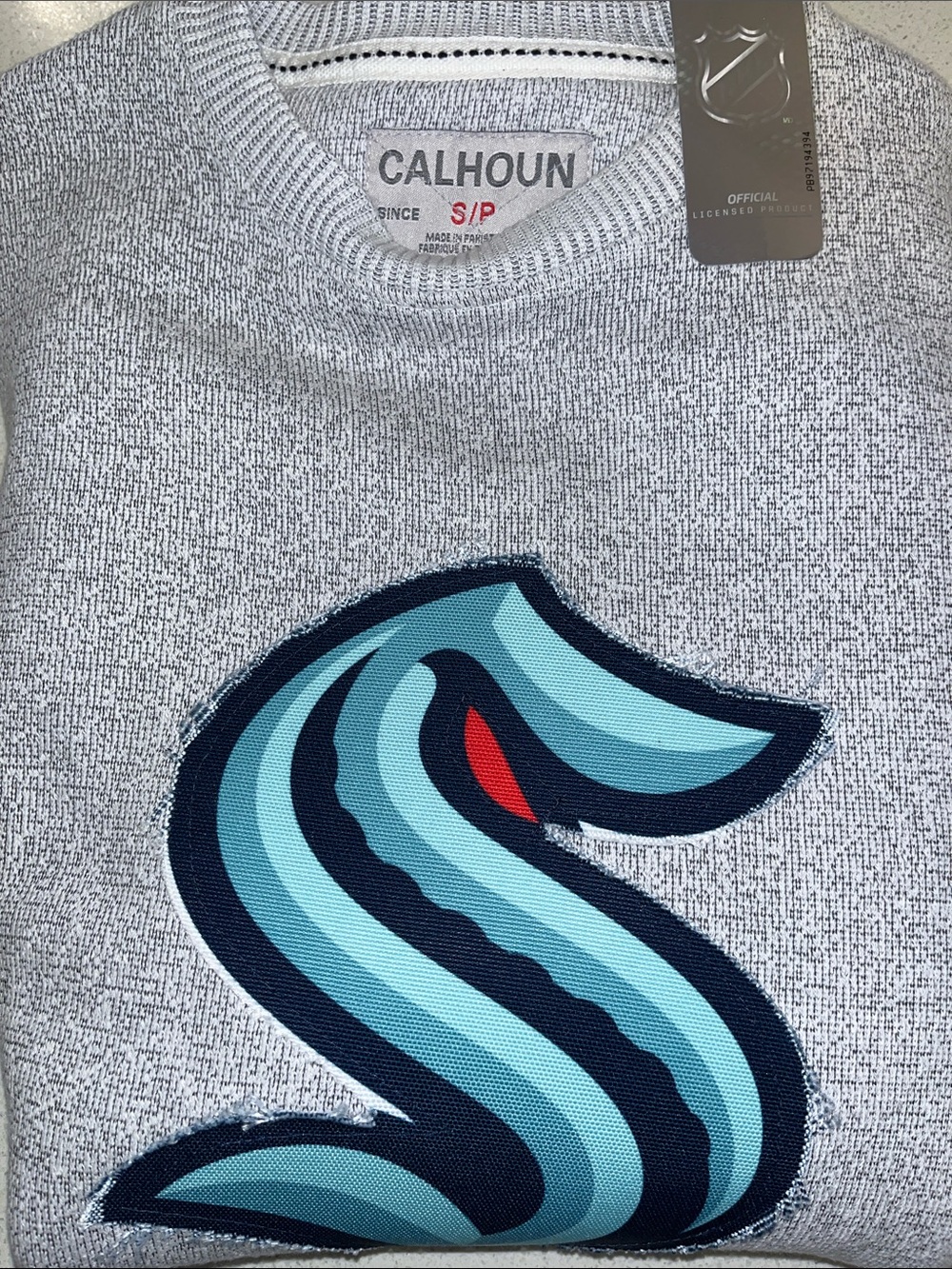 Calhoun Men’s Gray Crewneck Sweater with Teal 'S' Seattle Kraken Logo.